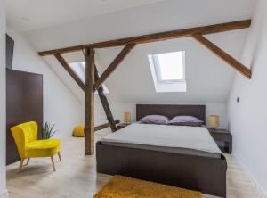 a bedroom with a bed and a yellow chair at Holiday Home Josipović 