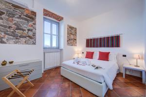 a bedroom with a large bed with red pillows at Aparthotel Arona in Arona +154 photos