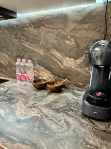 a coffee maker and two bottles of water on a counter at Luxury RA Apartment in Oradea