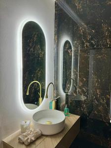 a bathroom with a large sink and two windows at Luxury RA Apartment in Oradea