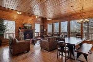 a living room with a table and chairs and a fireplace at Emerald City Lights #203 in Gatlinburg