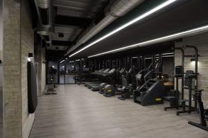 a gym with a row of treadms and machines at Sunset Gardens in Limassol
