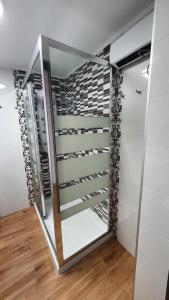 a walk in closet with a glass door at Sollana Arena in Valencia