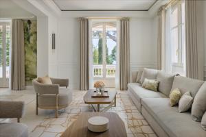 a living room with a couch and a table at Grand-Hôtel du Cap-Ferrat, A Four Seasons Hotel in Saint-Jean-Cap-Ferrat