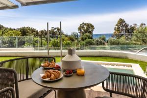 a table with two plates of pastries on it at Luxury Sea View Apartment by United Renters in Villajoyosa