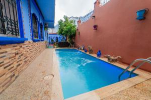 a swimming pool in the middle of a building at villa Rita chaouen in Chefchaouen