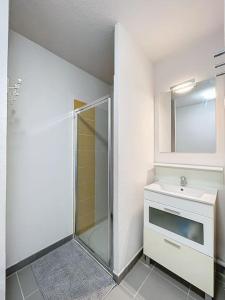a bathroom with a shower and a sink and a mirror at 3284 - appartement 4 couchages avec piscine in Argelès-sur-Mer