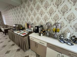 a kitchen with a counter top with some appliances at Qamar Hotel in Bukhara