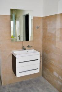 a bathroom with a white sink and a mirror at Lotos in Karlovy Vary