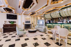 a lobby with a bar with chairs and a table at Hotel Strass in Paralia Katerinis