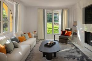 a living room with a couch and a table at Grand-Hôtel du Cap-Ferrat, A Four Seasons Hotel in Saint-Jean-Cap-Ferrat