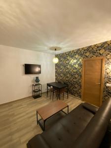 a living room with a couch and a table at Moncloa Urban Apartment in Madrid
