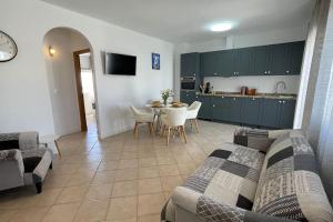 a living room and kitchen with a couch and a table at Casa Azahar luxury two bedroom top floor apartment in Alhaurín el Grande +23 photos