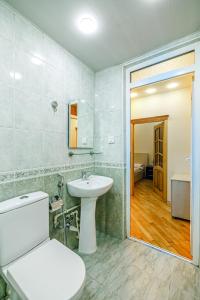 a bathroom with a white toilet and a sink at Boulvard M Estate in Baku