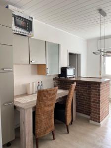 a kitchen with a wooden table and two chairs at Monteurewohnung L770 in Stemwede