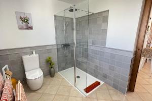 a bathroom with a glass shower with a toilet at Casa Azahar luxury two bedroom top floor apartment in Alhaurín el Grande