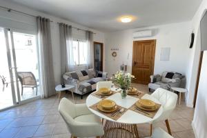 a living room with a table and chairs at Casa Azahar luxury two bedroom top floor apartment in Alhaurín el Grande