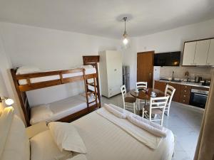 a living room with two bunk beds and a table at Villa A & A in Ksamil