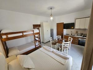 a living room with two bunk beds and a table at Villa A & A in Ksamil
