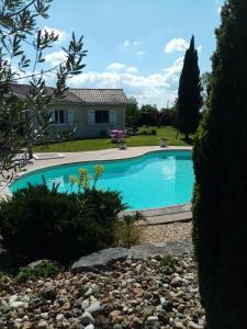 a swimming pool in the yard of a house at Le chêne blanc in La Genétouze