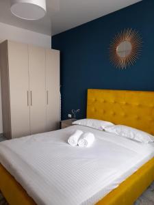 a bedroom with a large bed with two towels on it at Apartament Palma 2 Stefan Resort in Mamaia Sat/Năvodari