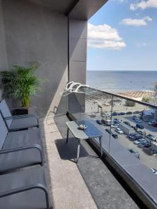 a balcony with a table and a view of the beach at Apartament Palma 2 Stefan Resort in Mamaia Sat/Năvodari