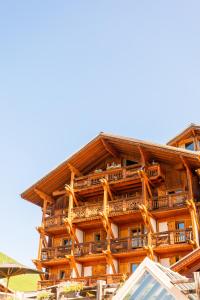 a building with balconies on the side of it at Hôtel Au Chamois d'Or by Les Etincelles in L'Alpe-d'Huez