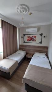 Postel nebo postele na pokoji v ubytování Kutberk Hotel Kemer