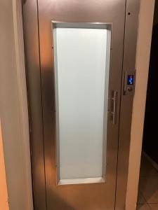 a door with a window in a elevator at Birinci Apart Hotel in Istanbul