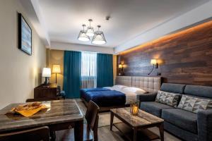 a living room with a bed and a couch at Residence Gudauri Hills in Gudauri