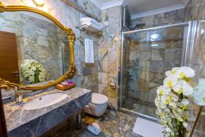 a bathroom with a sink and a shower and a toilet at Anatolia Hotel Airport in Trabzon +27 photos