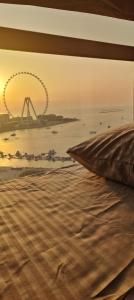 a view of the london eye from a bedroom with a bed at 1 WORLD, Premium Hostel, JBR, Near Metro and Beach in Dubai