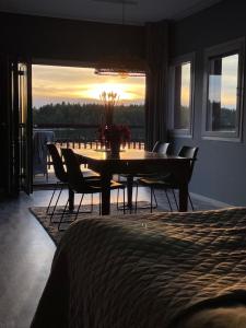 a dining room with a table and chairs with a view at Nordkust - Unikt boende med havsutsikt in Skärplinge