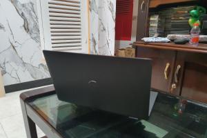 a laptop computer sitting on top of a glass table at OYO 93863 Dv Homestay Syariah Genteng in Surabaya