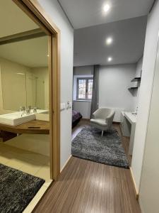 uma casa de banho com uma banheira, um lavatório e um espelho. em Quinta de VillaSete em Alpendurada