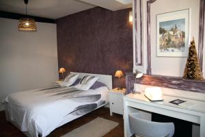 a bedroom with a bed and a desk with a computer at Sur les Pas de Cadet Roussel in Auxerre