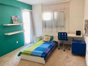 a bedroom with a bed and a desk and a chair at Modern Apartment near the Center by Platform 357 in Strovolos