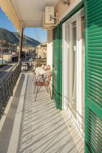 a balcony with a table and chairs on a building at A4 - Rosemary Apartment in Nydri