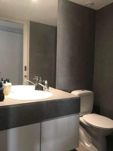 a bathroom with a sink and a toilet at Modern Apartment near the Center by Platform 357 in Strovolos