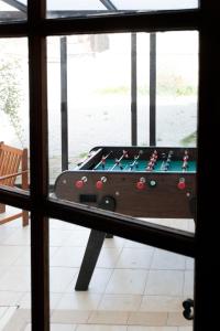 a pool table in a room with a window at Les Frangines - maison de ville avec jardin Ault in Ault