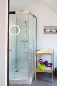 a shower with a glass door in a bathroom at Les Frangines - maison de ville avec jardin Ault in Ault