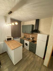 a kitchen with a white refrigerator and a stove at Moncloa Urban Apartment in Madrid