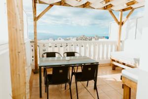 a dining room with a table and chairs on a balcony at Spacious 2 BR Golden Apartment by Aqua Vista Tenerife in Callao Salvaje