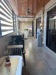 a restaurant with a table and chairs and a counter at Wilnags Inn Puerto Princesa near airport in Puerto Princesa City