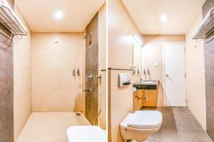 a small bathroom with a toilet and a shower at FabHotel Prime Royal Castle Gandhipuram in Coimbatore