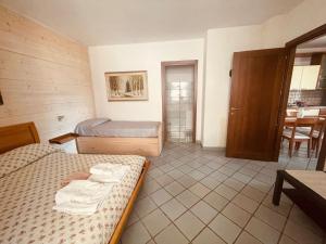 a hotel room with two beds and a table at Casa Vacanze Spigolatrice in Sapri