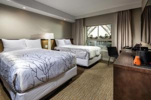 Cama o camas de una habitación en Hotel Aventura
