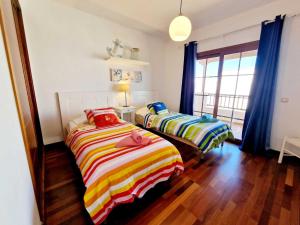 Łóżko lub łóżka w pokoju w obiekcie Casa Daniela en Costa Teguise