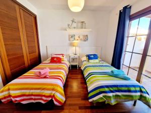 Łóżko lub łóżka w pokoju w obiekcie Casa Daniela en Costa Teguise