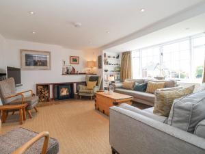 a living room with a couch and a fireplace at Beta Cottage in Southwold